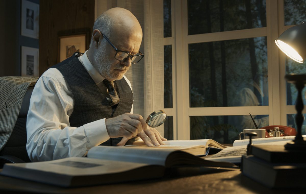 Senior academic researcher working in his office